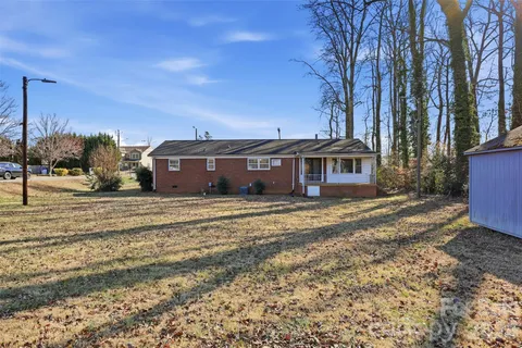 a view of a house with a yard in the background