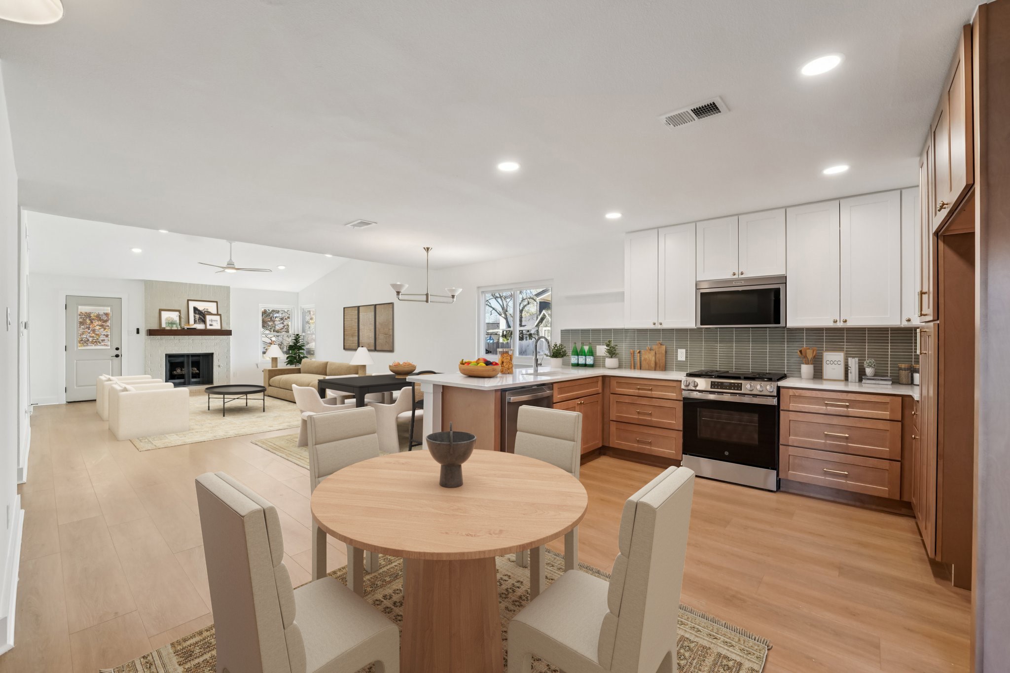 4901 Transit Circle Austin, TX 78727 - Photo 28 of 29 a kitchen with stainless steel appliances kitchen island granite countertop a stove a sink a microwave a dining table and chairs