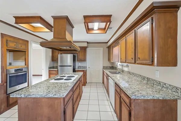 a kitchen with stainless steel appliances granite countertop a sink stove and cabinets