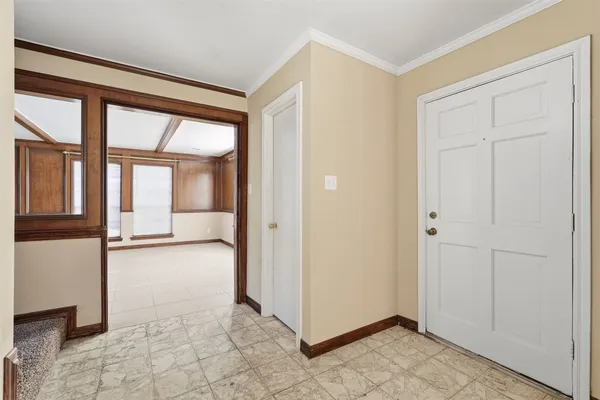 a view of a livingroom with an empty space and a window