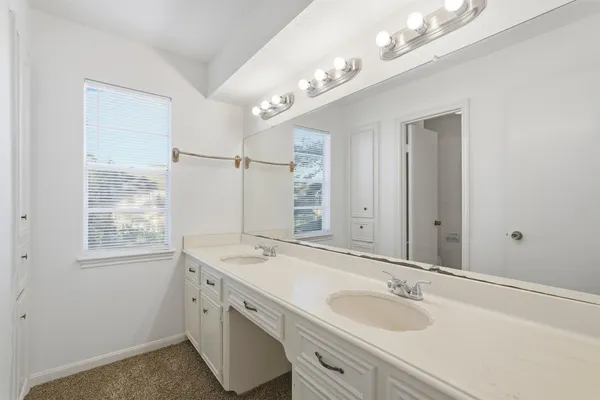 a bathroom with a sink double vanity and a mirror