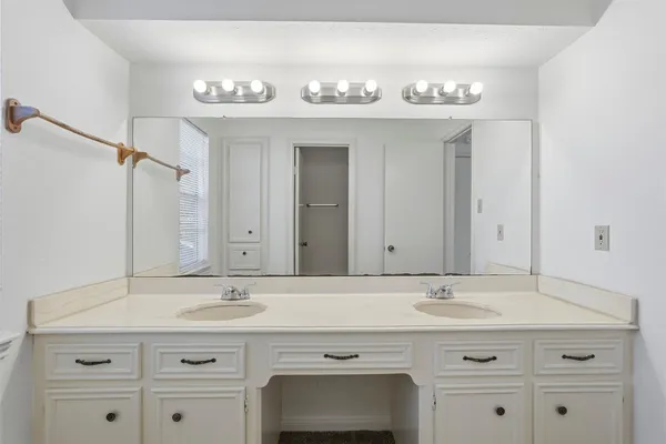 a bathroom with a sink vanity and a mirror