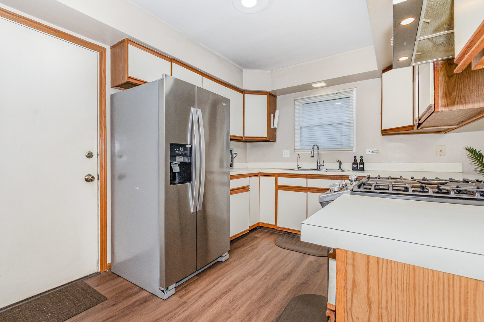 1201 Oak Ridge Drive Streamwood, IL 60107 - Photo 12 of 36 a kitchen with a refrigerator a sink and wooden floor
