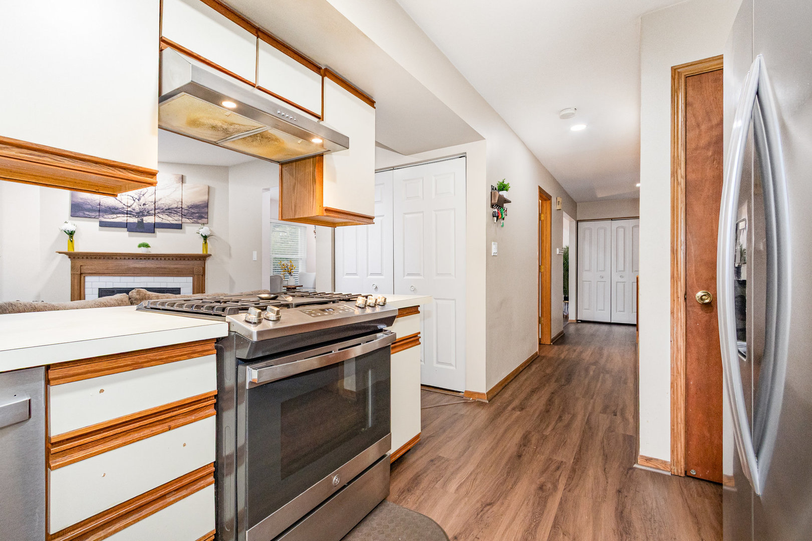 1201 Oak Ridge Drive Streamwood, IL 60107 - Photo 13 of 36 a kitchen with stainless steel appliances granite countertop a stove and a refrigerator
