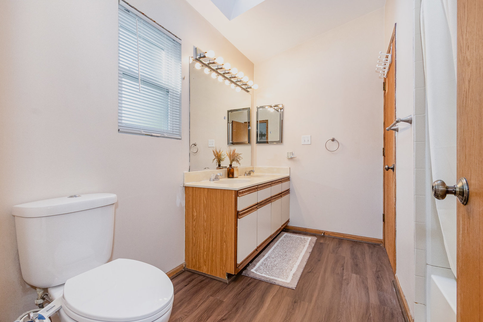 1201 Oak Ridge Drive Streamwood, IL 60107 - Photo 19 of 36 a bathroom with a sink vanity mirror and toilet