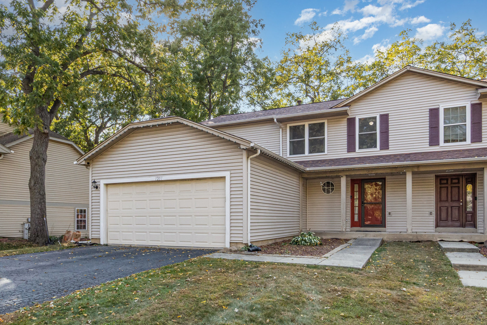 1201 Oak Ridge Drive Streamwood, IL 60107 - Photo 2 of 36 a view of a yard in front of a house with large tree