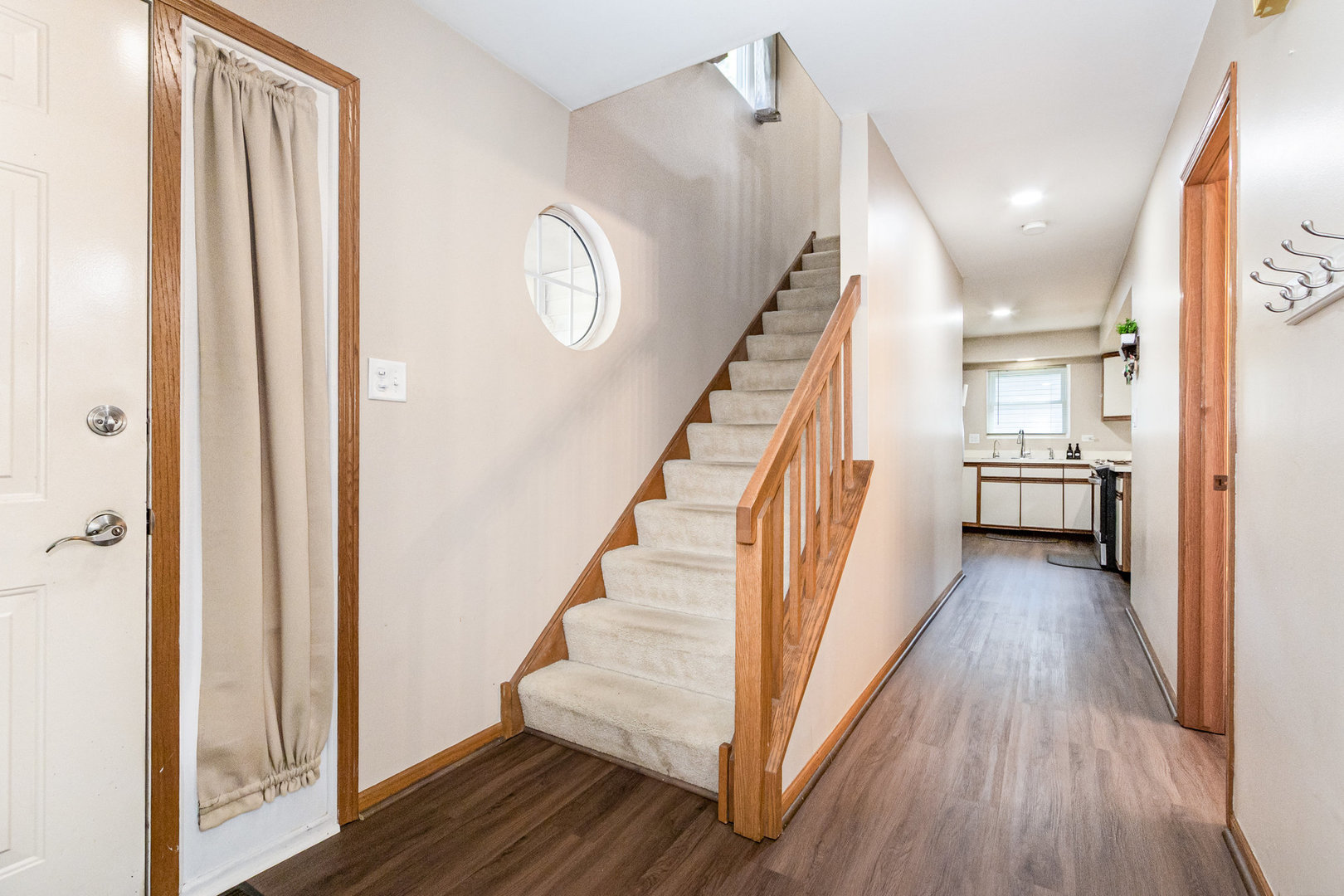 1201 Oak Ridge Drive Streamwood, IL 60107 - Photo 3 of 36 a view of a hallway with wooden floor and staircase