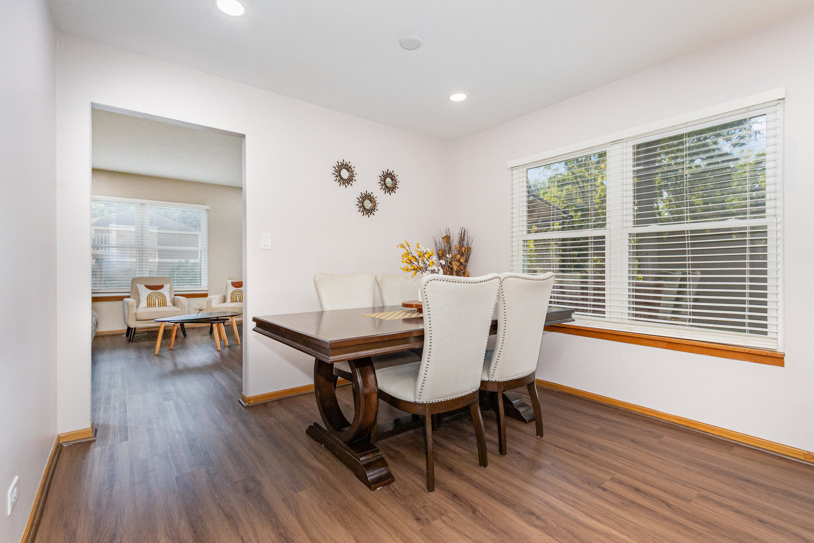1201 Oak Ridge Drive Streamwood, IL 60107 - Photo 7 of 36 a dining room with furniture wooden floor and a rug