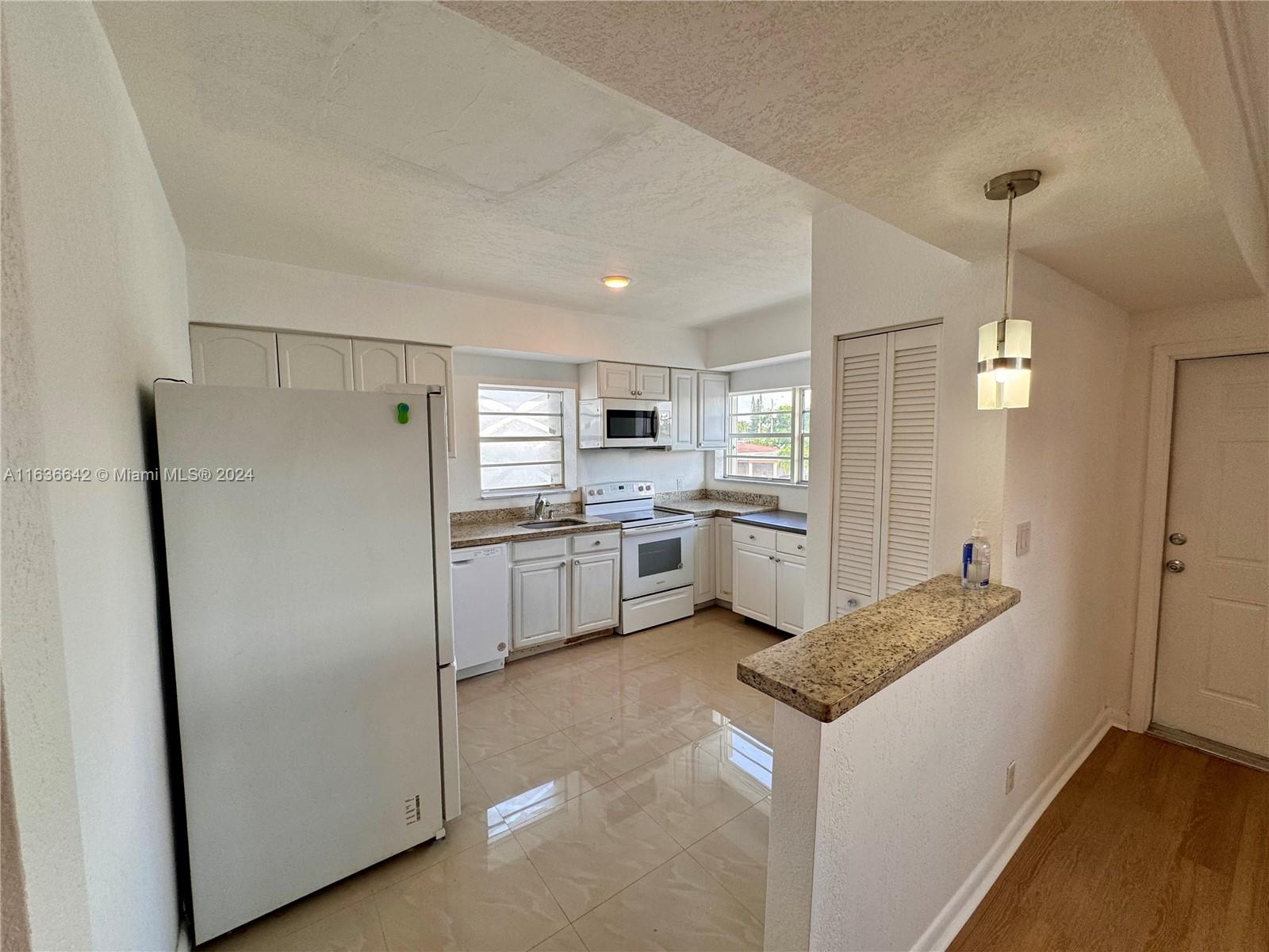 934 79th Terrace, Unit 2 Miami Beach, FL 33141 - Photo 1 of 42 a kitchen with a refrigerator a sink and dishwasher