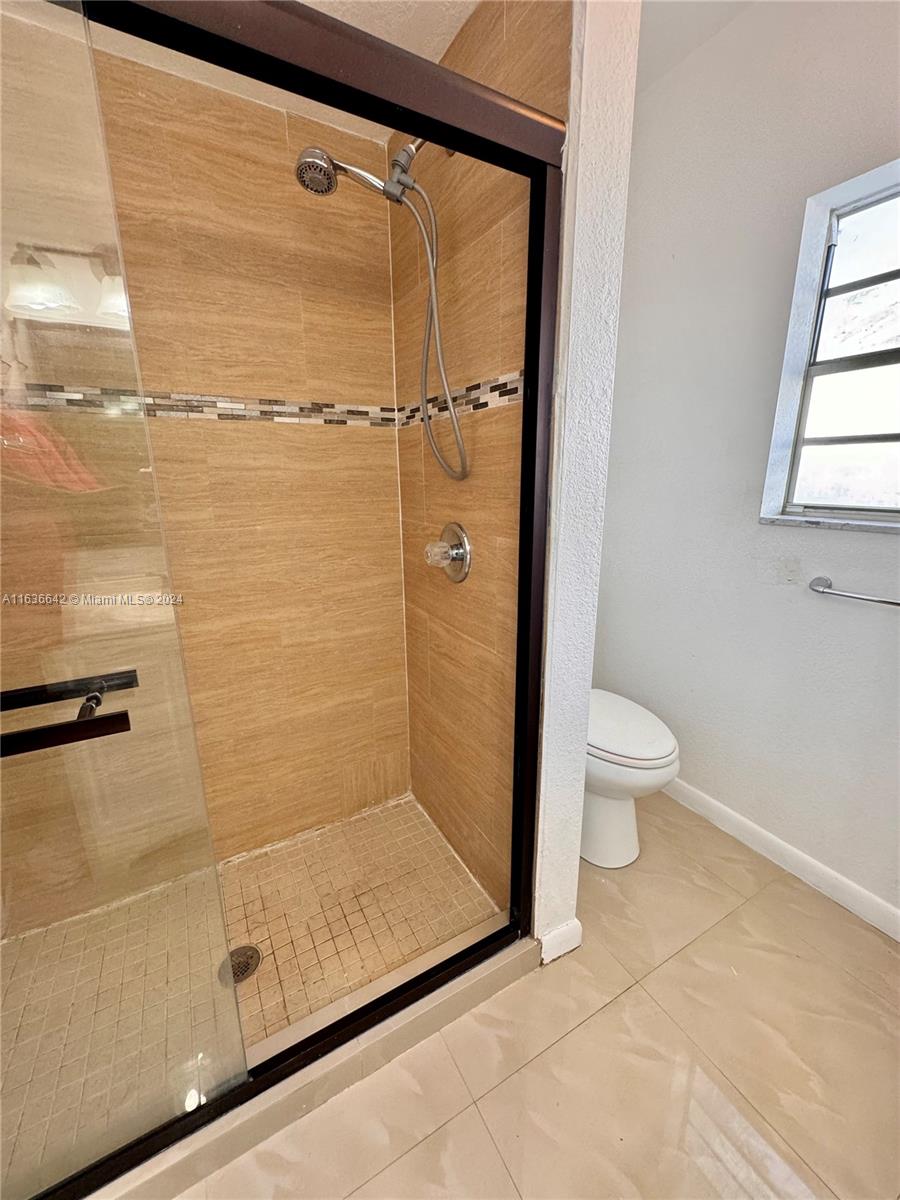 934 79th Terrace, Unit 2 Miami Beach, FL 33141 - Photo 13 of 42 a bathroom with a shower