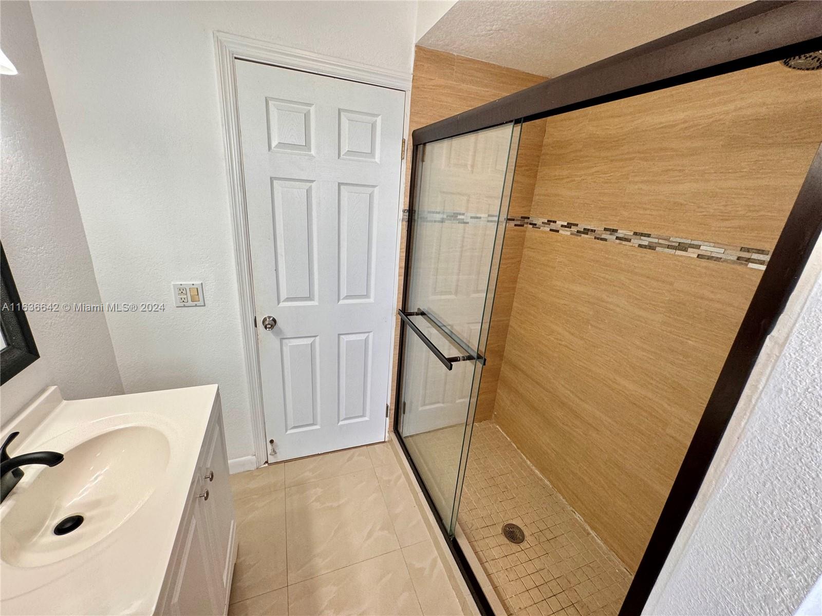 934 79th Terrace, Unit 2 Miami Beach, FL 33141 - Photo 15 of 42 a bathroom with a shower and a sink