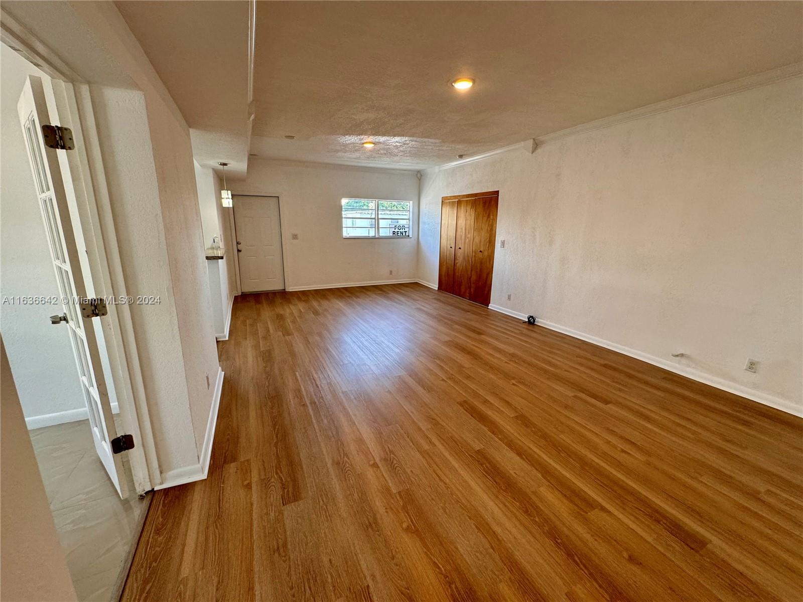 934 79th Terrace, Unit 2 Miami Beach, FL 33141 - Photo 2 of 42 wooden floor in an empty room with a window