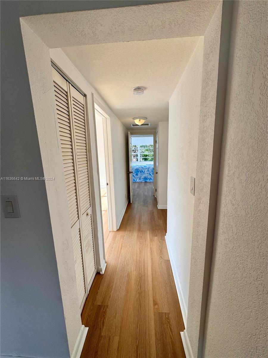 934 79th Terrace, Unit 2 Miami Beach, FL 33141 - Photo 22 of 42 a view of a hallway with wooden floor and staircase