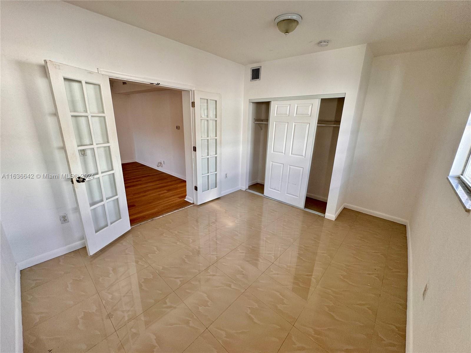 934 79th Terrace, Unit 2 Miami Beach, FL 33141 - Photo 23 of 42 an empty room with windows