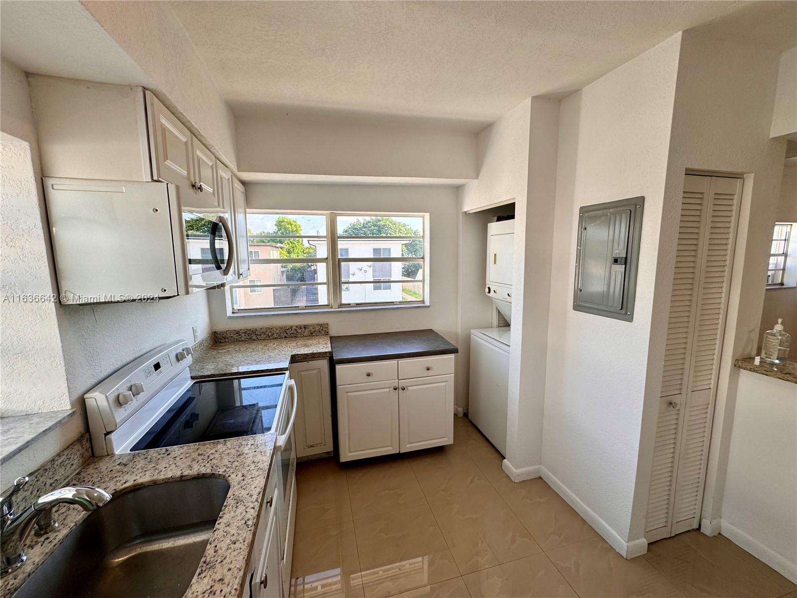 934 79th Terrace, Unit 2 Miami Beach, FL 33141 - Photo 27 of 42 a kitchen with a stove a refrigerator and a sink