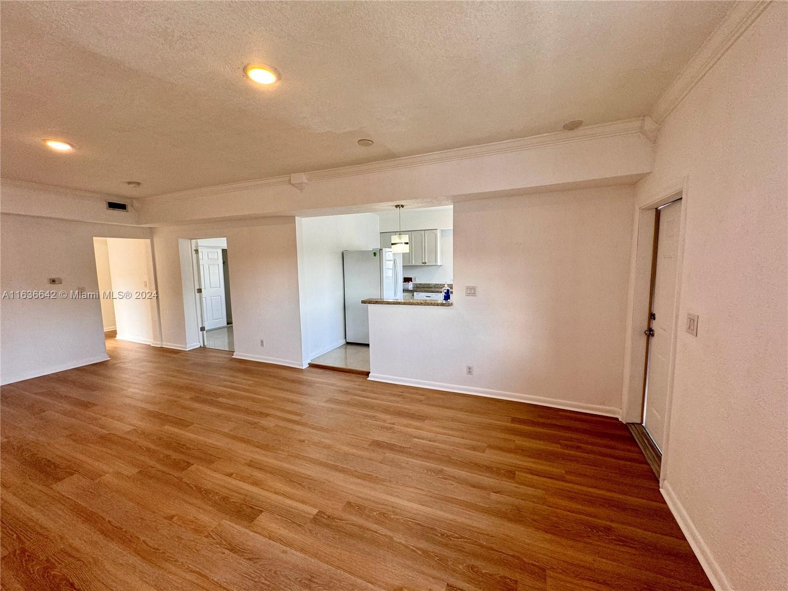 934 79th Terrace, Unit 2 Miami Beach, FL 33141 - Photo 31 of 42 a view of an empty room with wooden floor and a window