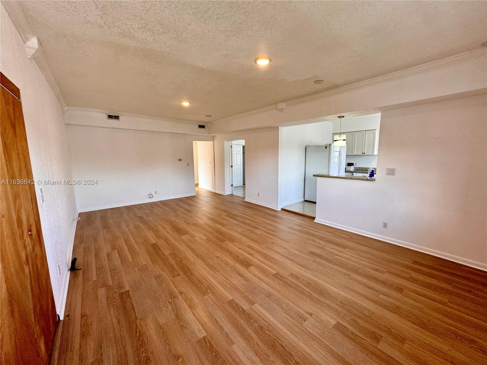 934 79th Terrace, Unit 2 Miami Beach, FL 33141 - Photo 32 of 42 a view of empty room with wooden floor