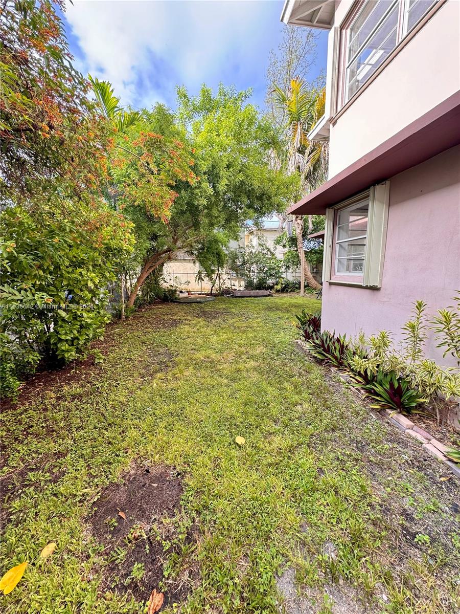 934 79th Terrace, Unit 2 Miami Beach, FL 33141 - Photo 40 of 42 a backyard of a house with lots of green space