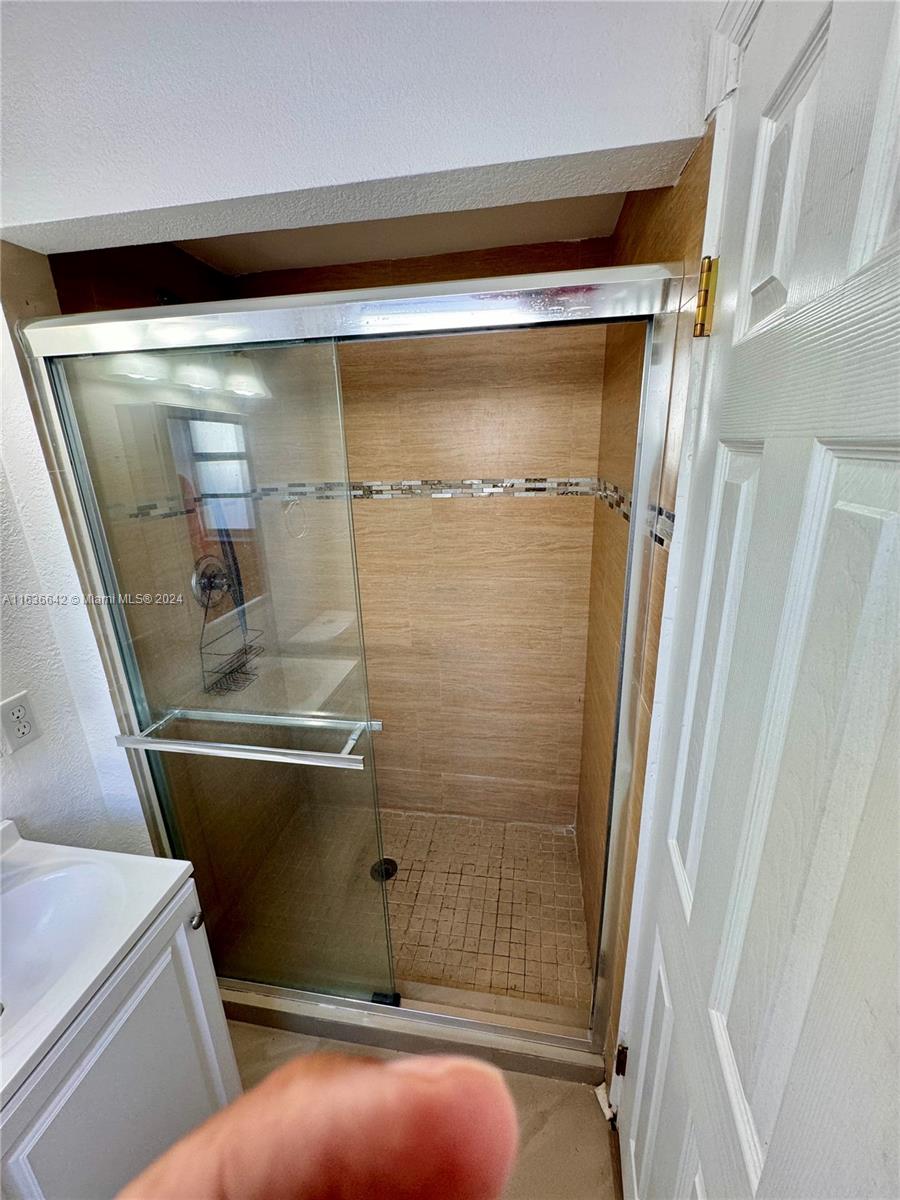 934 79th Terrace, Unit 2 Miami Beach, FL 33141 - Photo 7 of 42 a bathroom with a shower and toilet