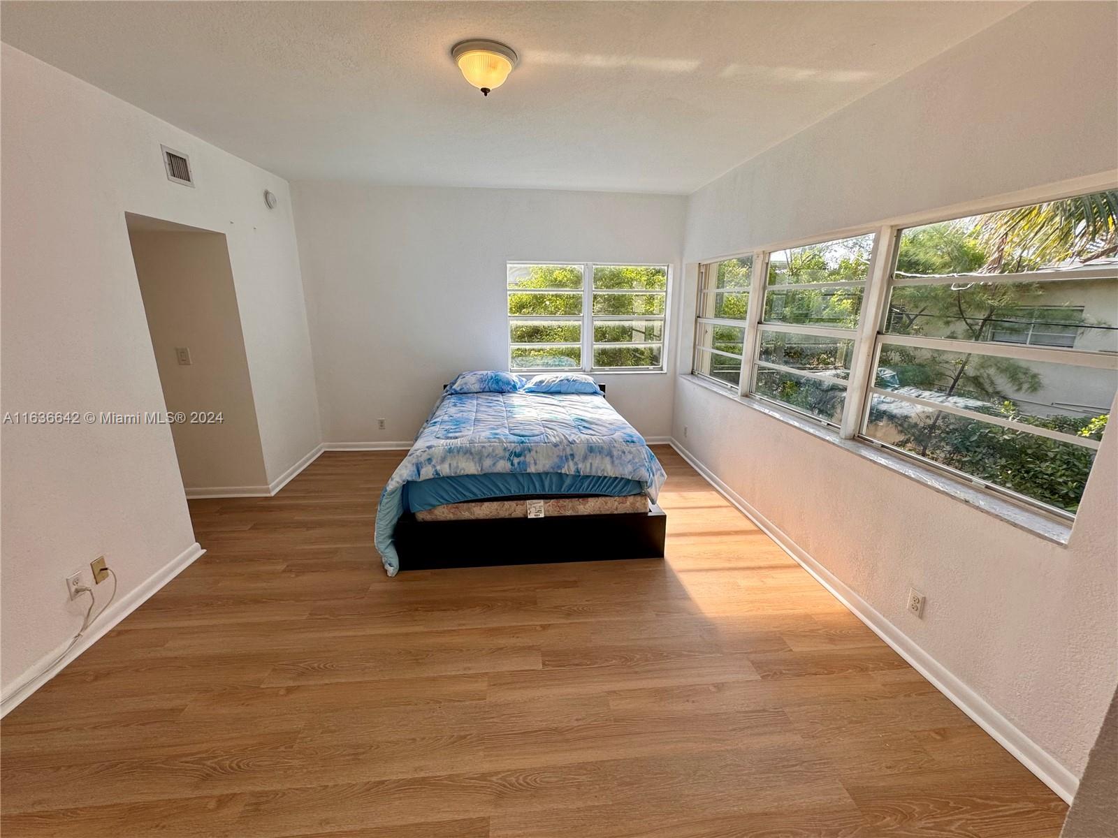 934 79th Terrace, Unit 2 Miami Beach, FL 33141 - Photo 10 of 42 a room with pool table and windows