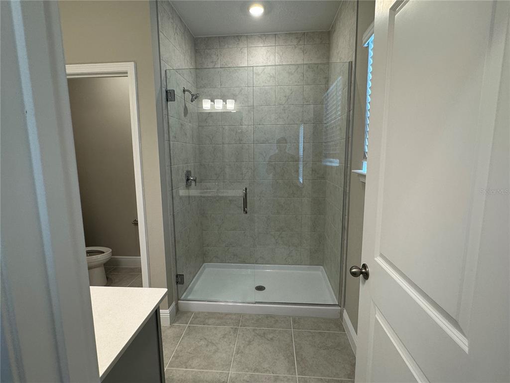 16434 Hamlin Hills Road Winter Garden, FL 34787 - Photo 25 of 50 a bathroom with a shower and a toilet