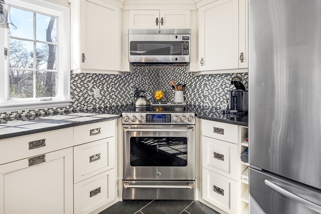 36 Howland Lane Hingham, MA 02043 - Photo 11 of 33 a kitchen with granite countertop white cabinets and white appliances