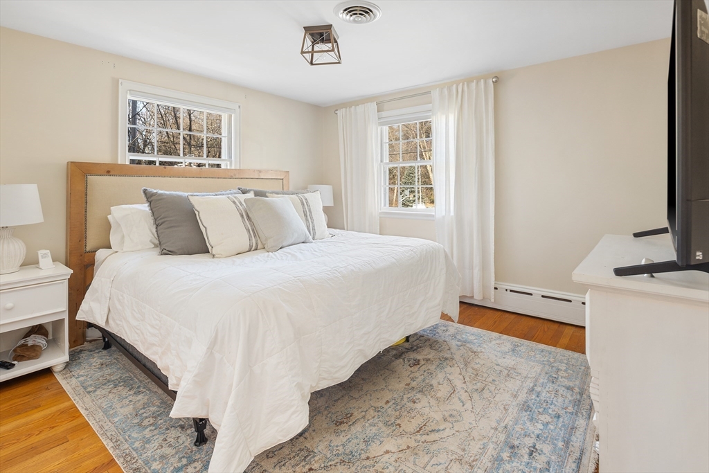 36 Howland Lane Hingham, MA 02043 - Photo 14 of 33 a bed room with a bed and a couch
