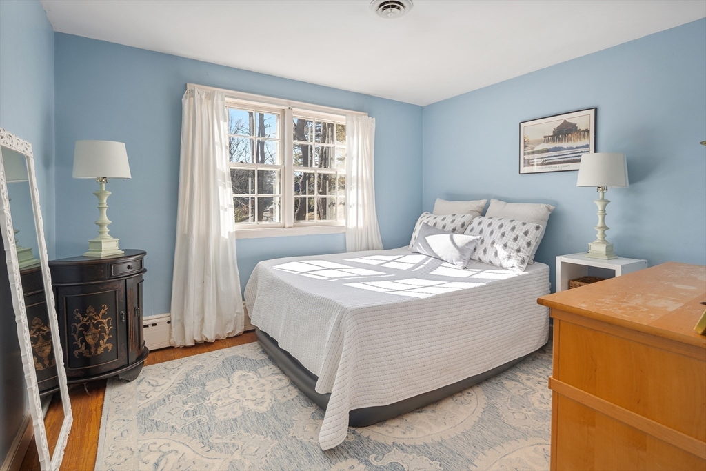 36 Howland Lane Hingham, MA 02043 - Photo 15 of 33 a bedroom with a bed a couch and a window
