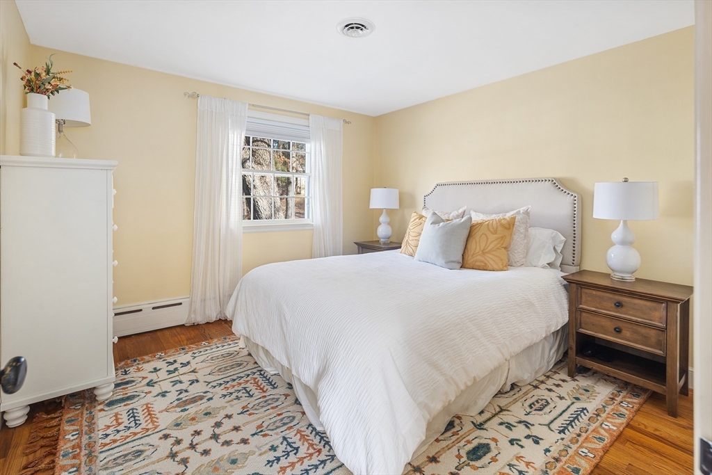36 Howland Lane Hingham, MA 02043 - Photo 16 of 33 a bedroom with a bed and a lamp on the dresser