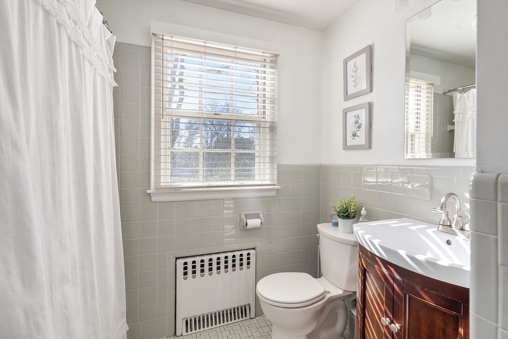 36 Howland Lane Hingham, MA 02043 - Photo 18 of 33 a bathroom with a granite countertop toilet a sink and a window