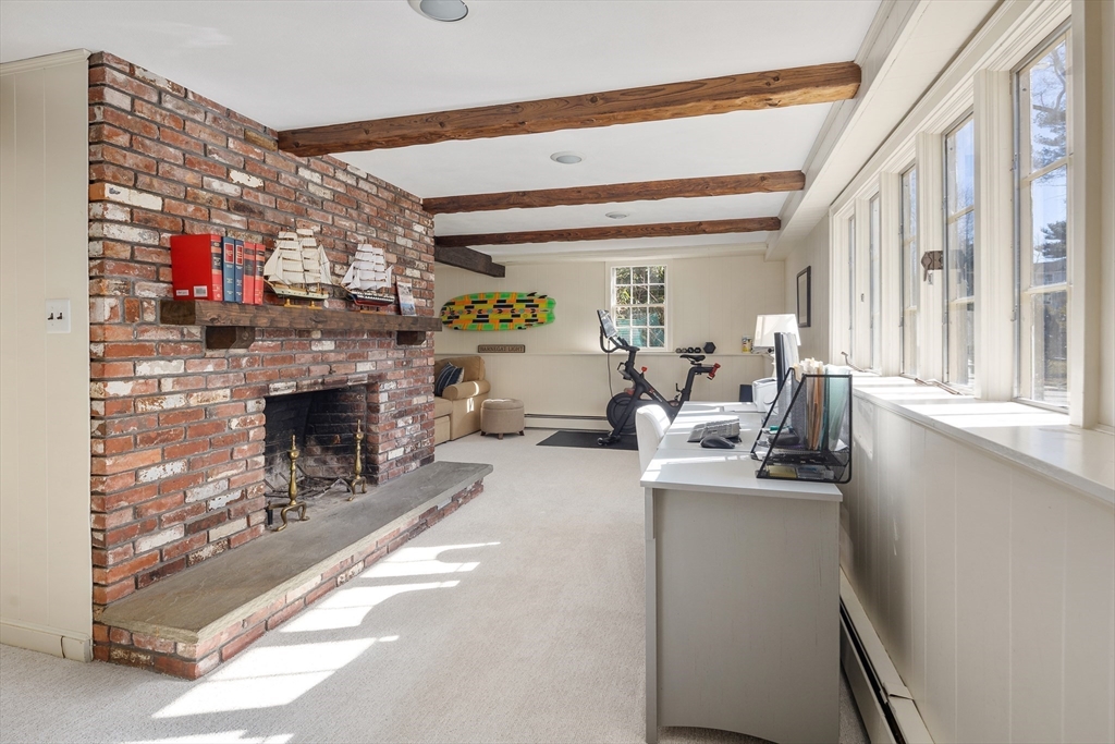 36 Howland Lane Hingham, MA 02043 - Photo 21 of 33 a living room with furniture a fireplace and a floor to ceiling window