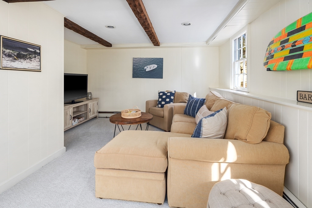 36 Howland Lane Hingham, MA 02043 - Photo 23 of 33 a living room with furniture and a flat screen tv