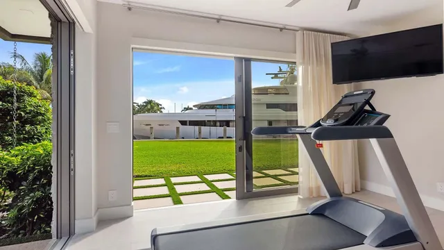 a living room with a bed and flat screen tv