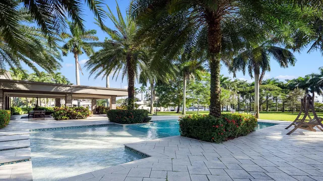 a view of a house with a yard and palm trees