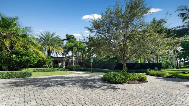 a view of a park with a house in background