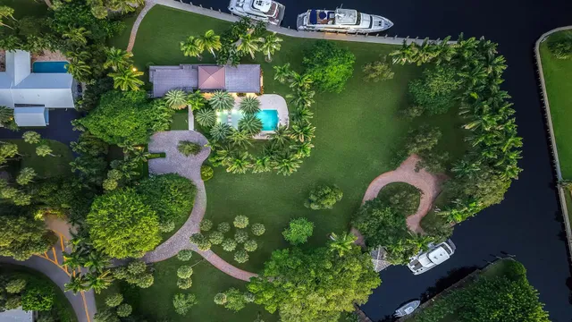 an aerial view of a residential houses with swimming pool and outdoor space