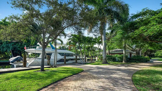 a view of a patio with a table and chairs under an umbrella