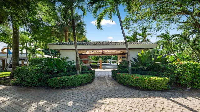 an aerial view of a residential houses with outdoor space and trees