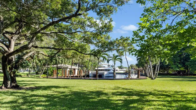 a view of house with outdoor seating area and lake view