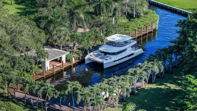 a view of a swimming pool with a patio and a yard