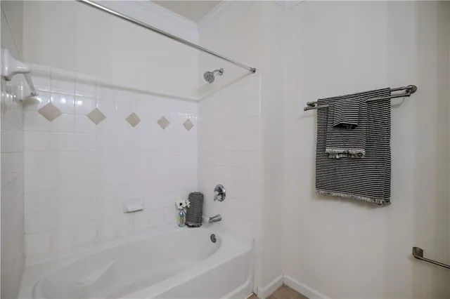 a bathroom with a bathtub and shower