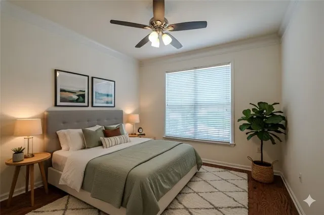 a bedroom with a bed and a potted plant