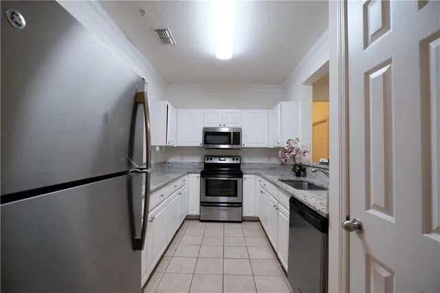 a kitchen with stainless steel appliances a refrigerator stove and microwave