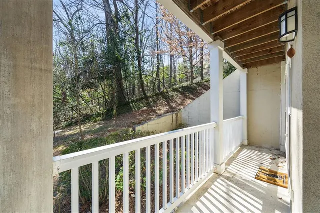 a balcony with furniture and wooden floor