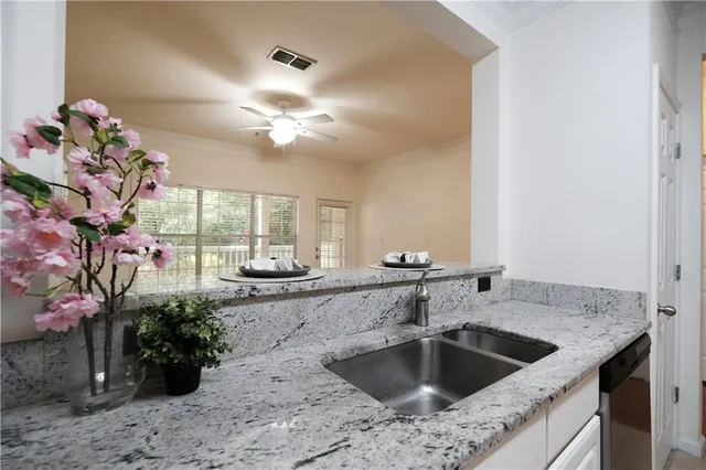 a kitchen with a sink and chandelier