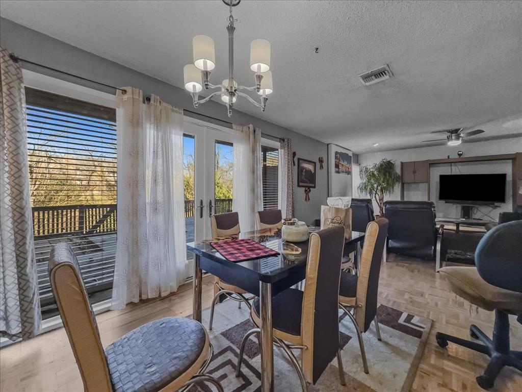 8411 Oak Streme Dallas, TX 75243 - Photo 14 of 28 a view of a dining room with furniture window and wooden floor