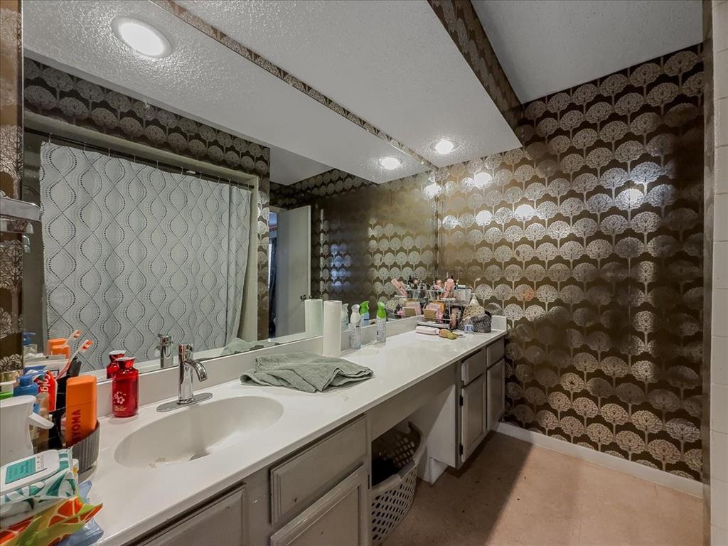 8411 Oak Streme Dallas, TX 75243 - Photo 17 of 28 a bathroom with a sink and a mirror
