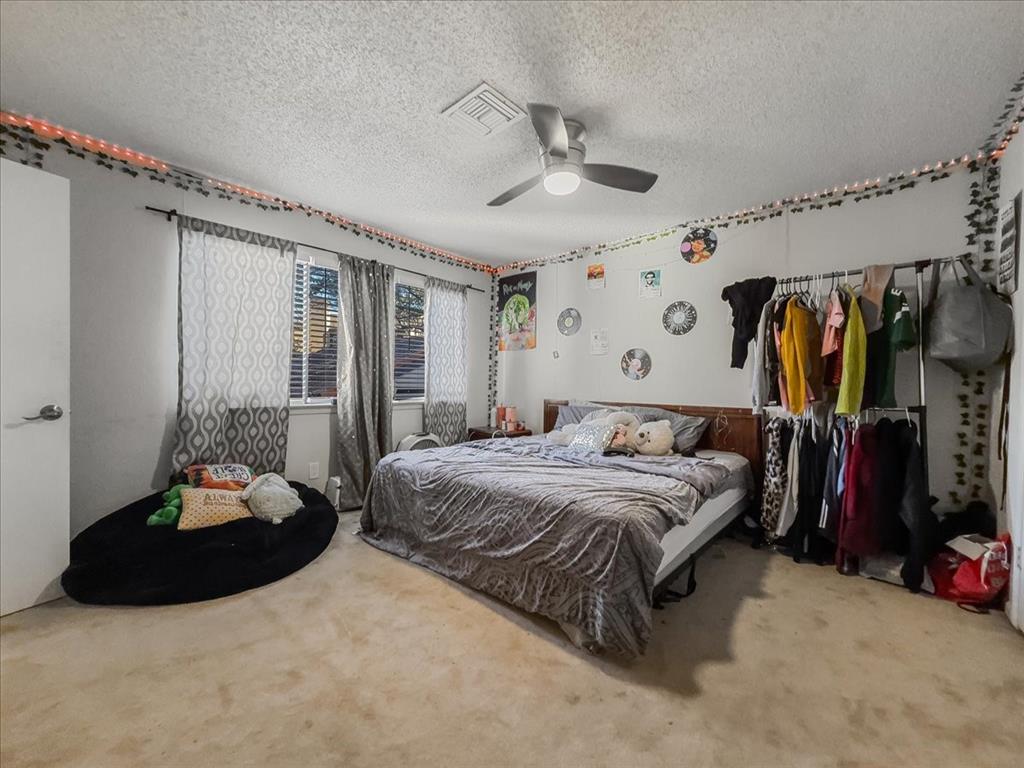 8411 Oak Streme Dallas, TX 75243 - Photo 20 of 28 a bedroom with a bed and a large mirror
