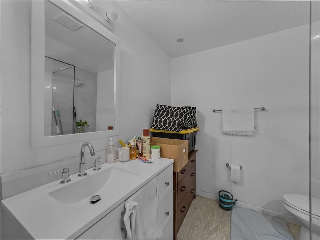 8411 Oak Streme Dallas, TX 75243 - Photo 23 of 28 a bathroom with a sink toilet and shower