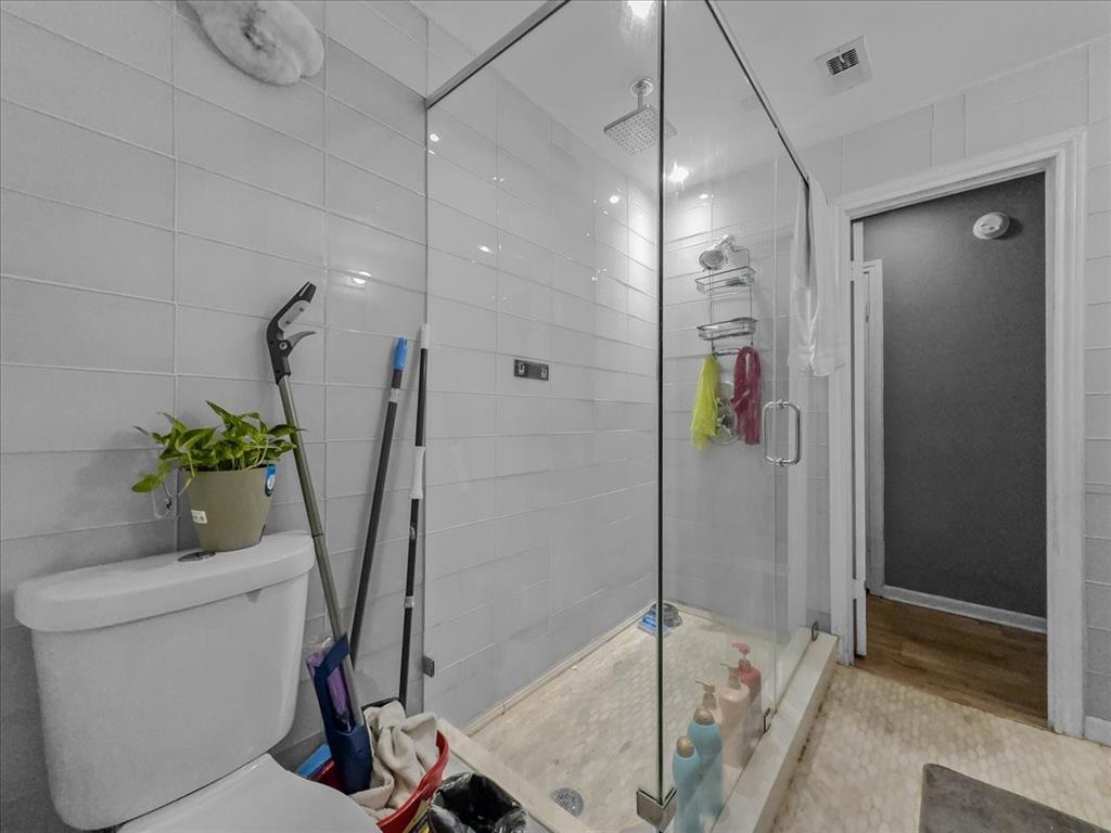 8411 Oak Streme Dallas, TX 75243 - Photo 25 of 28 a bathroom with a shower and a plant in it